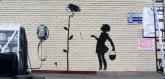 Banksy’s “Flower Girl” mural, created on the wall of a Los Angeles gas station, is to be auctioned in December